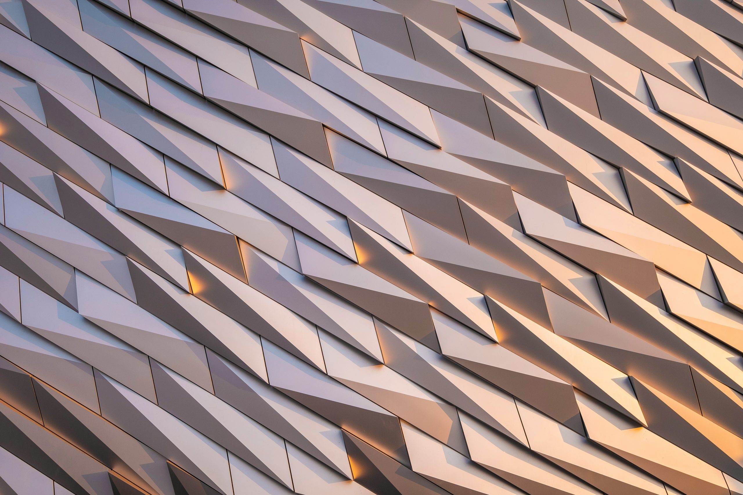 Abstract view of concentric circles forming a tunnel-like vortex in warm tones.
